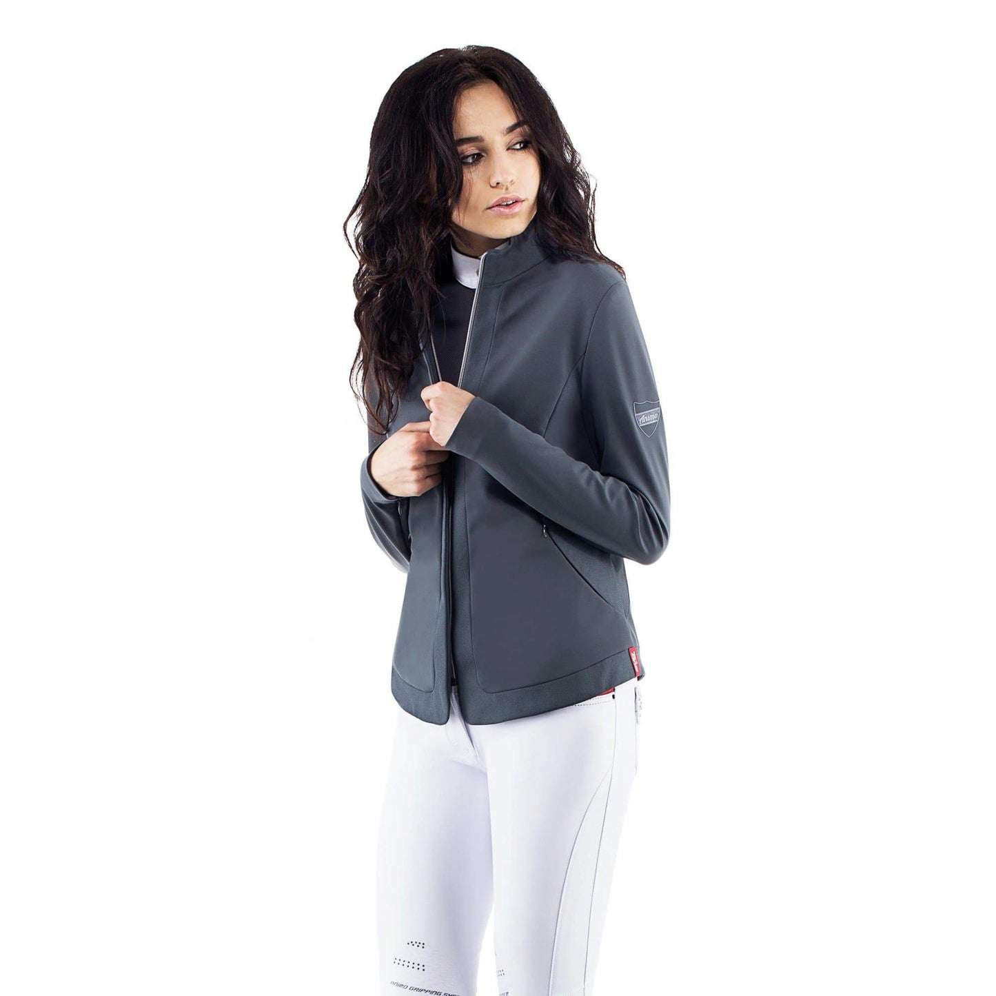 Woman in Animo brand jacket and white pants, looking away.