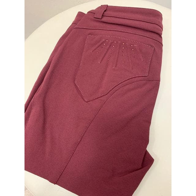 Animo brand burgundy breeches with decorative pocket detailing.