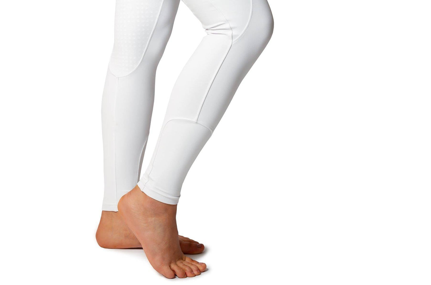 Person wearing white horse riding tights against an isolated background.