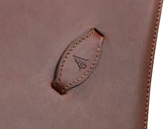 Arena Saddles logo embossed on brown leather surface detail.
