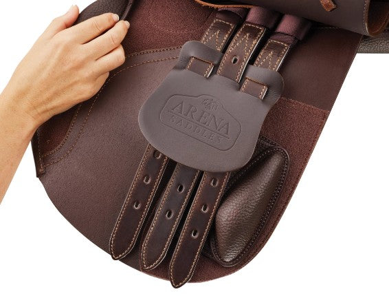 Close-up of brown Arena Saddles equestrian saddle with logo.