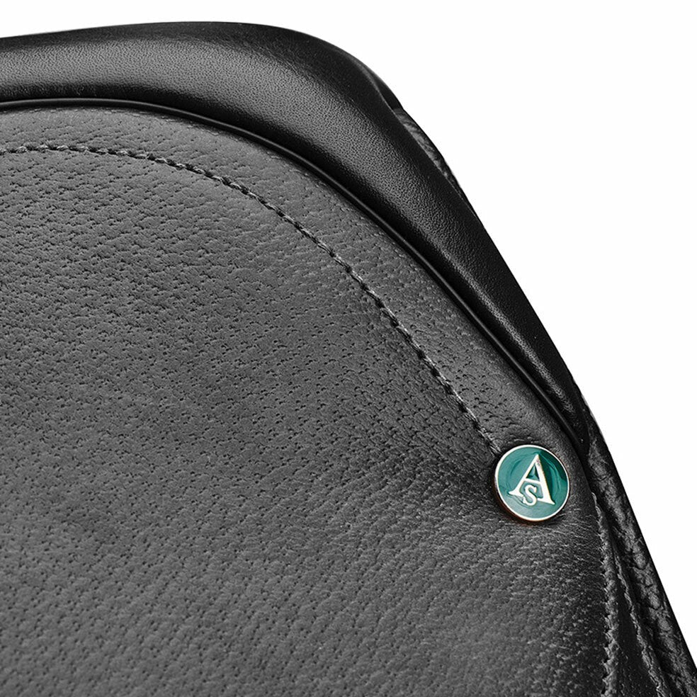 Close-up of black Arena Saddles logo on textured saddle leather.