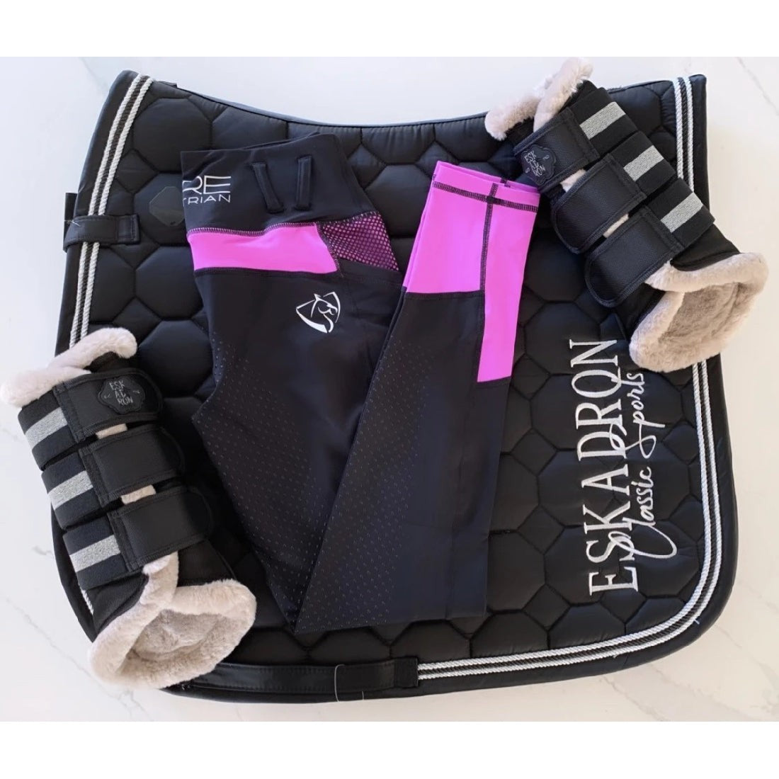 Equestrian gear with horse riding tights and leg supports displayed.