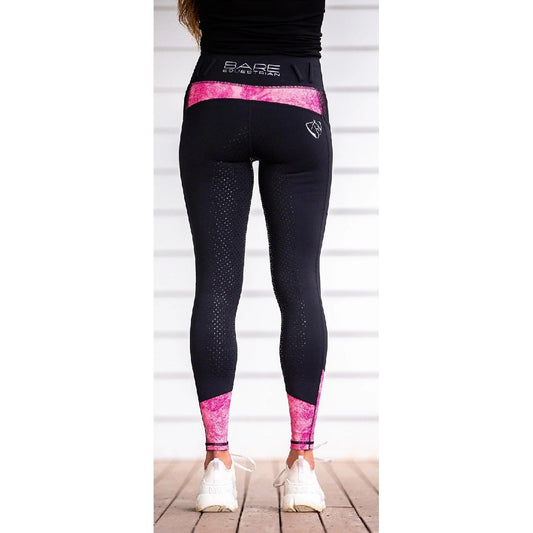 Person standing in black and pink horse riding tights.