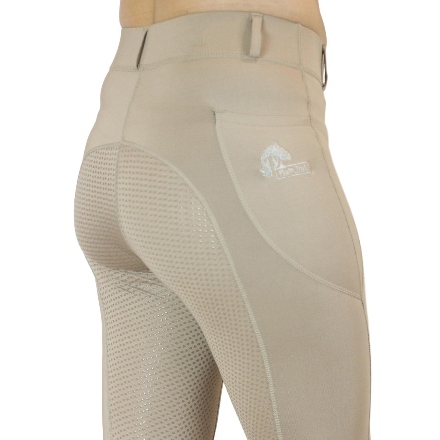 Person wearing beige horse riding tights with mesh detailing.