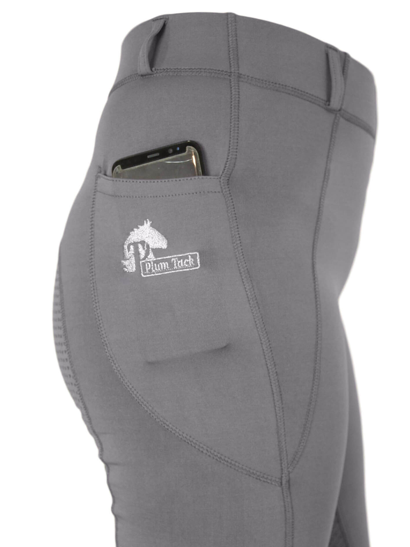 Close-up of grey horse riding tights with phone pocket detail.