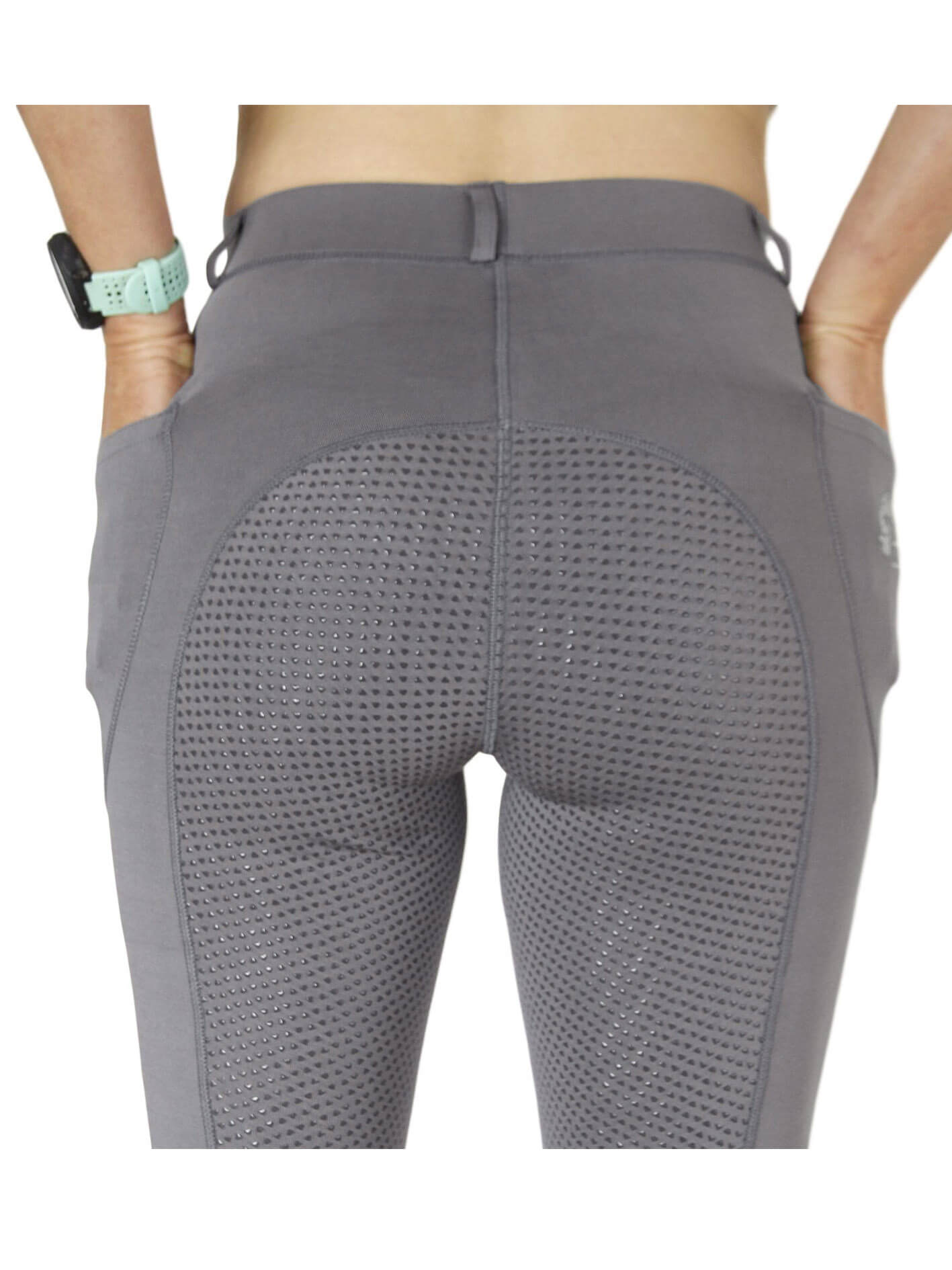 Person wearing grey ventilated horse riding tights, rear view.