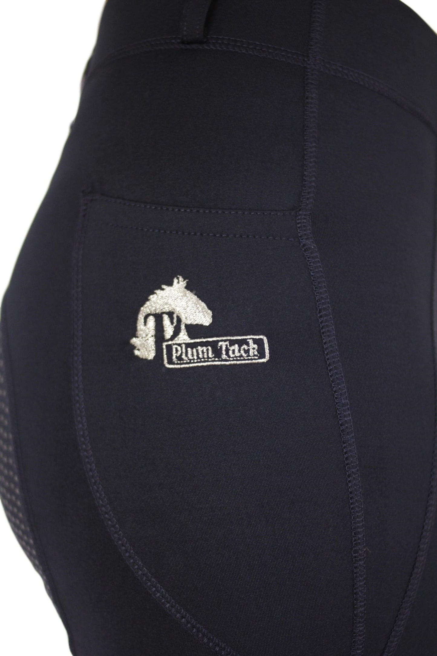 Close-up of navy horse riding tights with embroidered logo "Plum Tack."