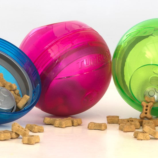 Rogz Tumbler dog toy balls in pink and green with treats.