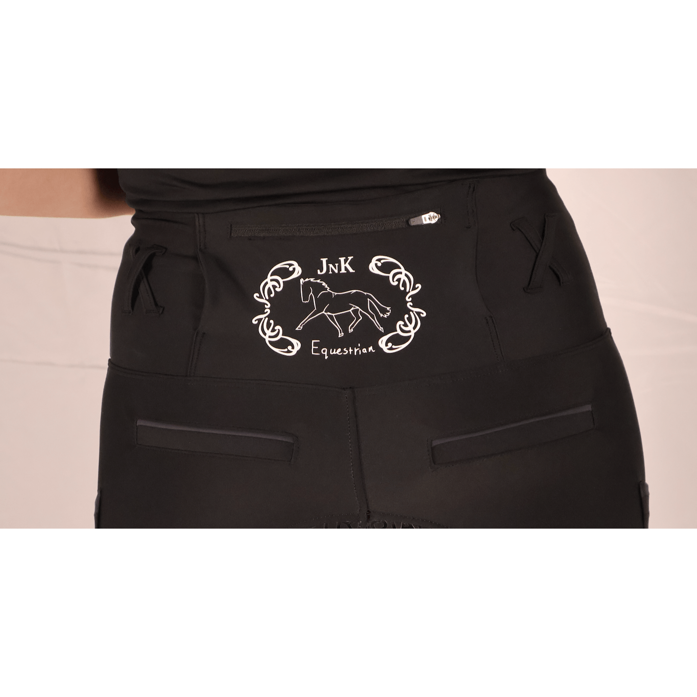 Close-up of black Horse Riding Tights with white equestrian logo.