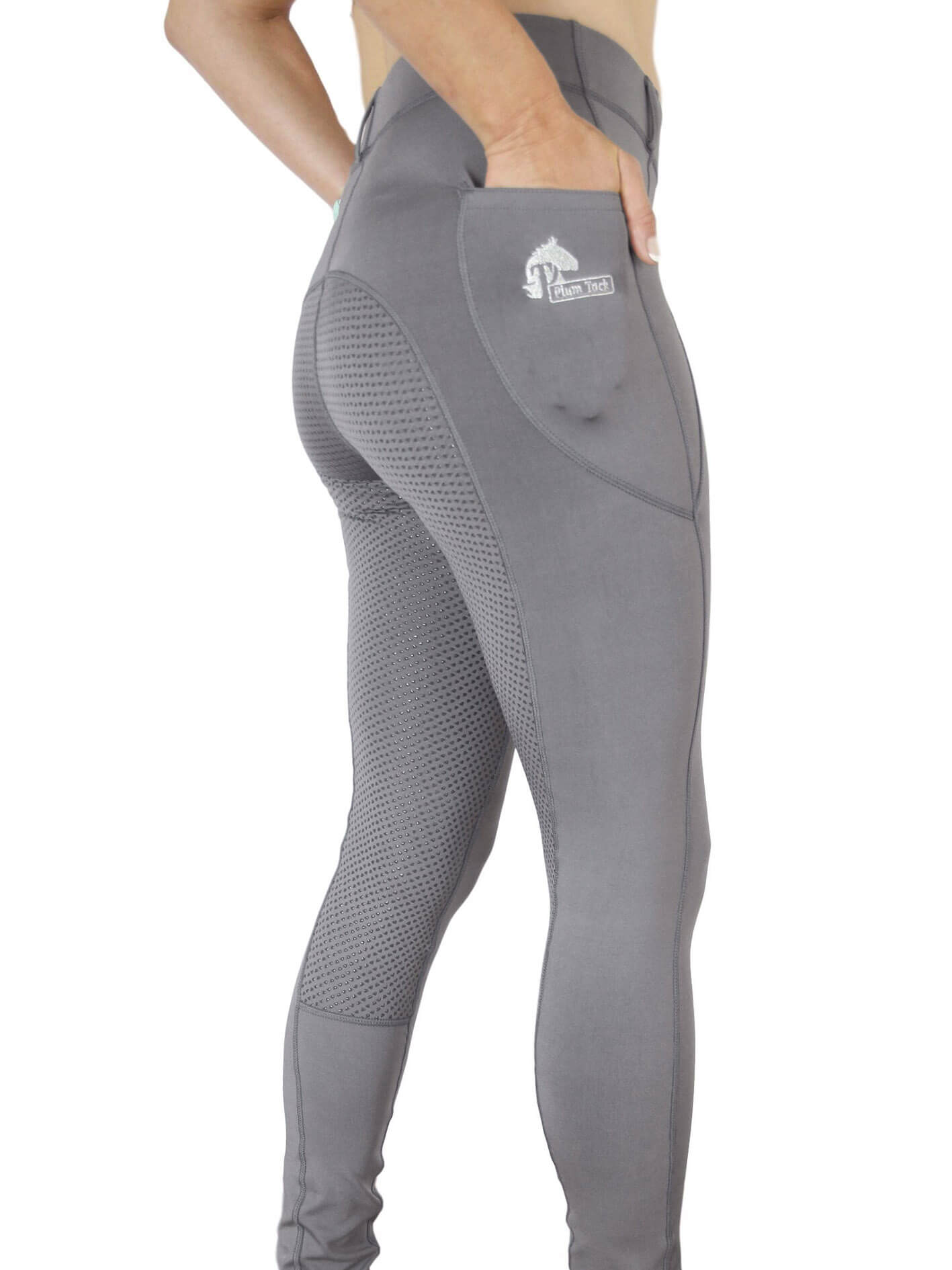 Gray horse riding tights on person, close-up side view.