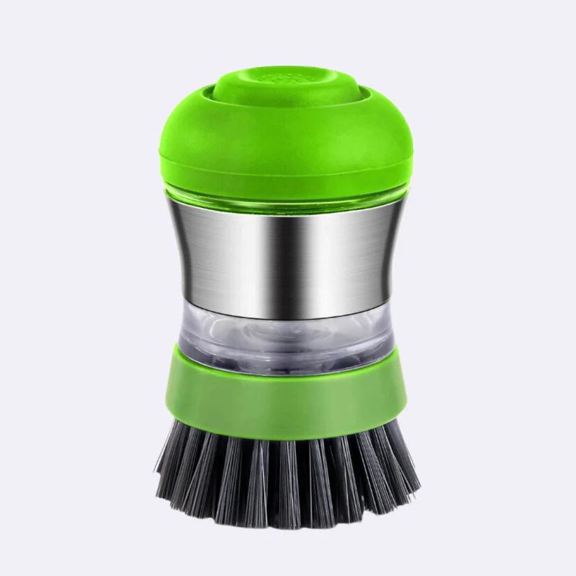 A green and stainless steel dishwashing brush with a transparent soap dispenser and black bristles, isolated on a white background.