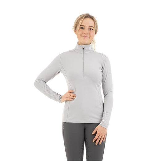 Woman in ANKY light grey zippered equestrian sports top.