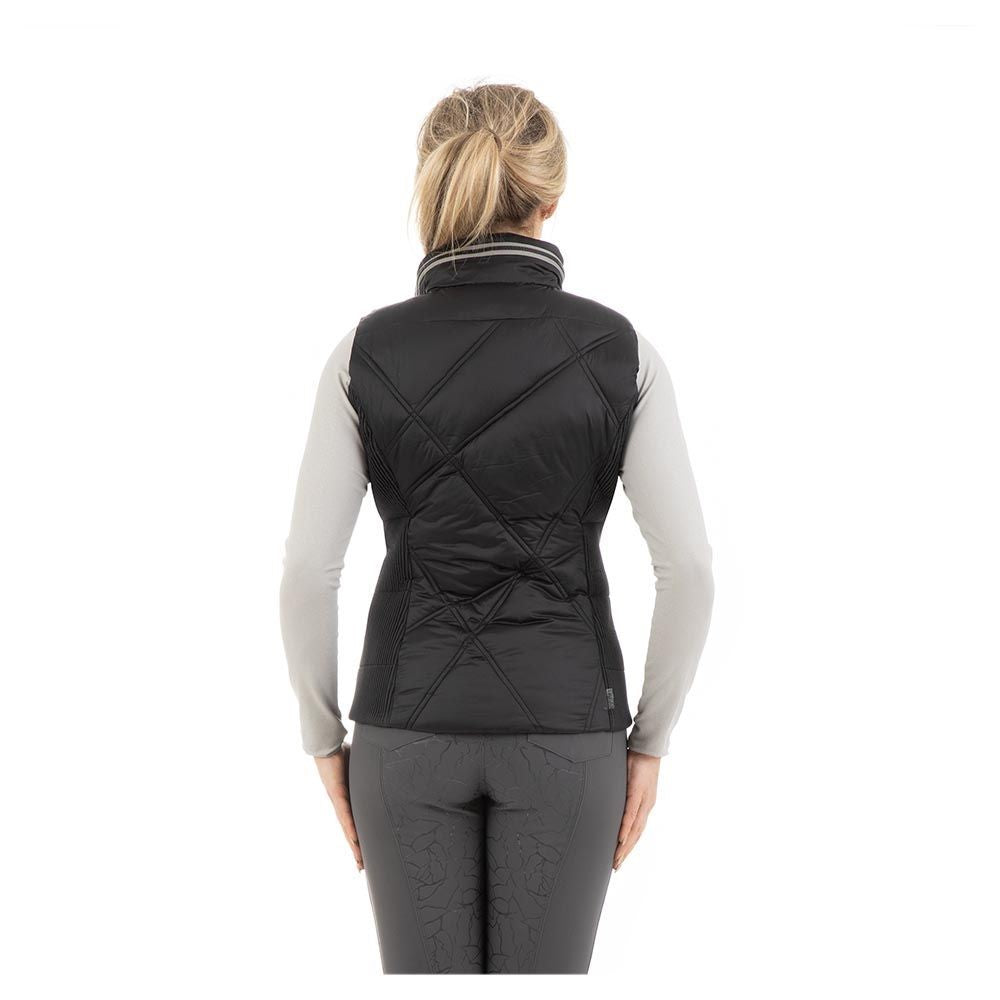 Woman wearing ANKY black quilted equestrian style vest.