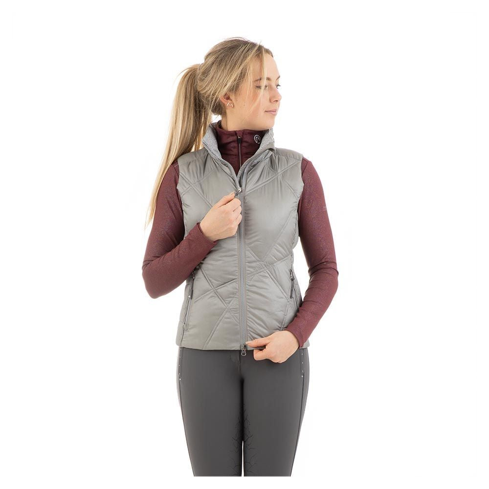 ANKY brand quilted grey vest on woman with burgundy top.