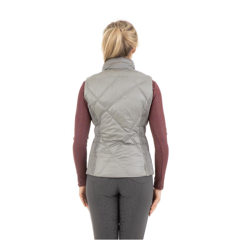 Woman wearing ANKY quilted light grey equestrian vest.