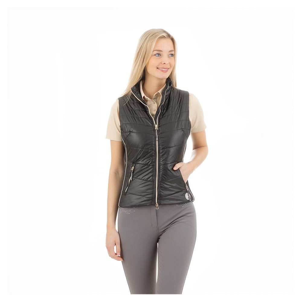 "ANKY brand quilted black equestrian vest on smiling woman."