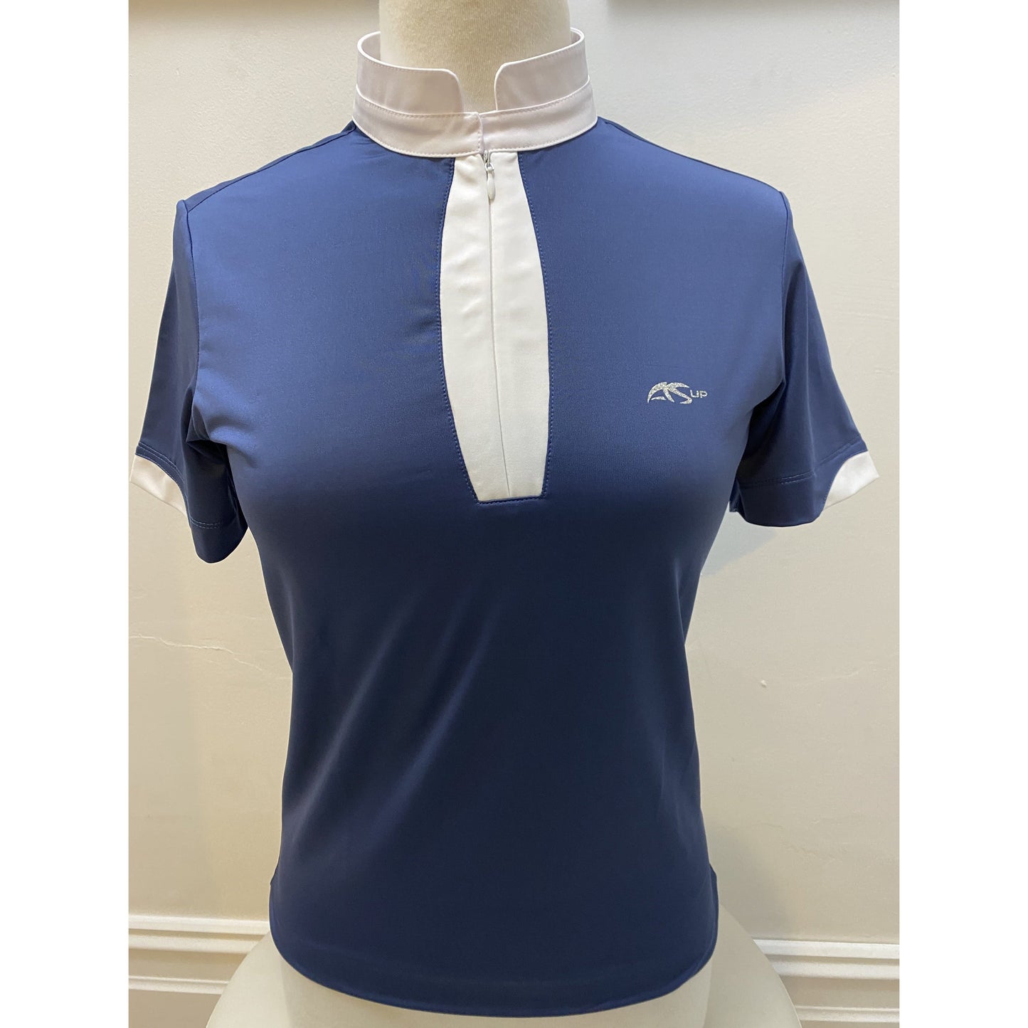 Anna Scarpati navy blue equestrian shirt with white collar on mannequin.