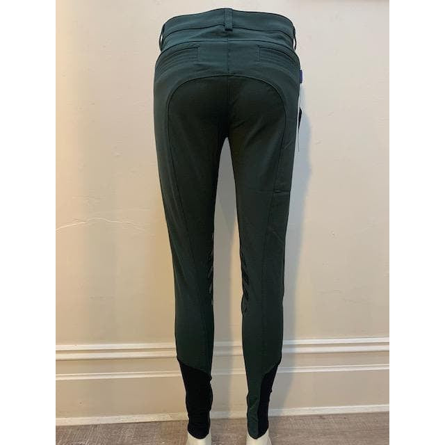 Rear view of green Anna Scarpati riding pants against a wall.