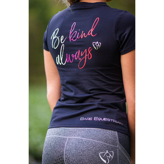 Woman in black horse riding tights with inspirational shirt text.