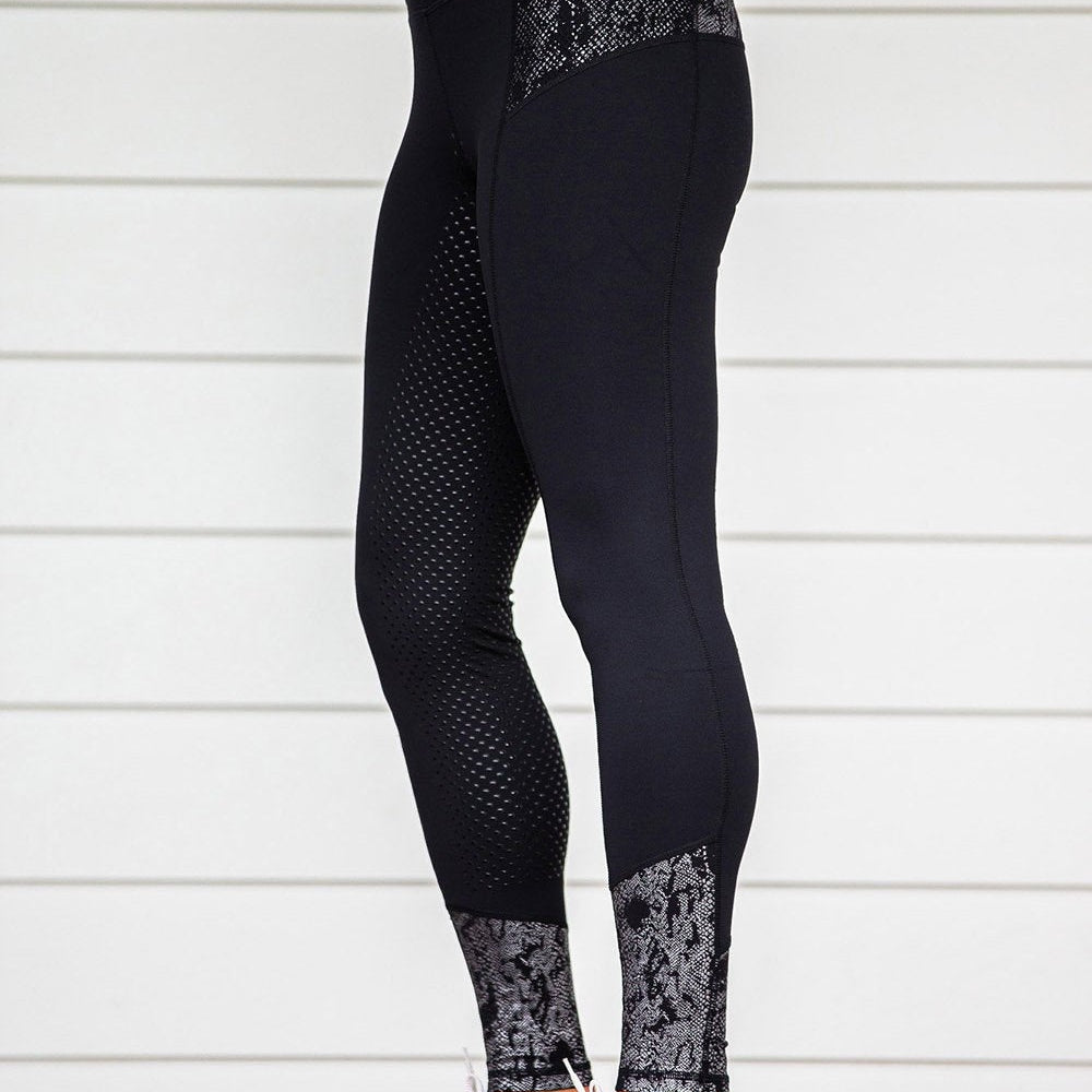 Black horse riding tights with mesh and lace detailing, standing pose.