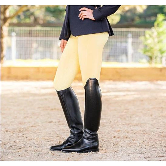 Person in beige horse riding tights and black riding boots.