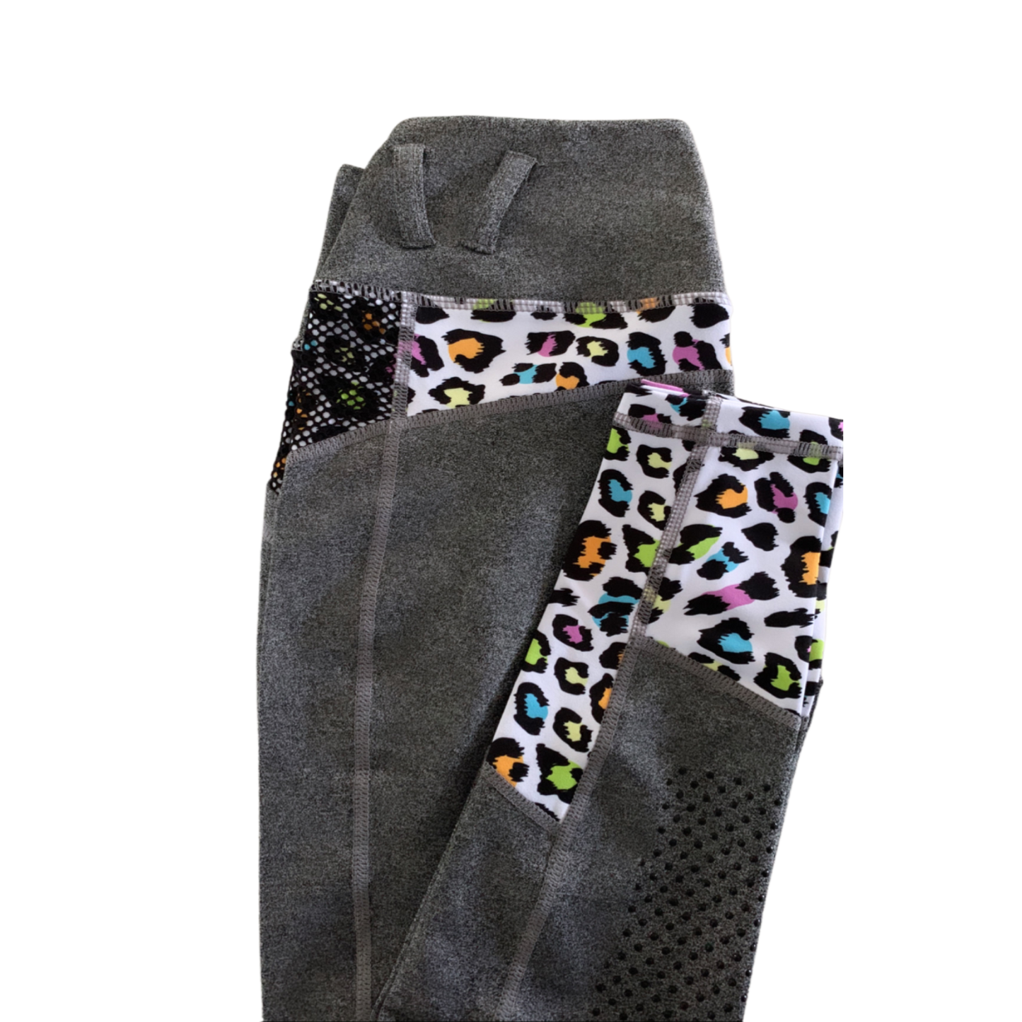 Folded gray horse riding tights with colorful waistband on black background.