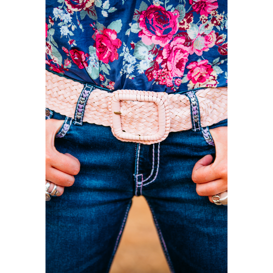 Floral shirt, jeans, woven belt.