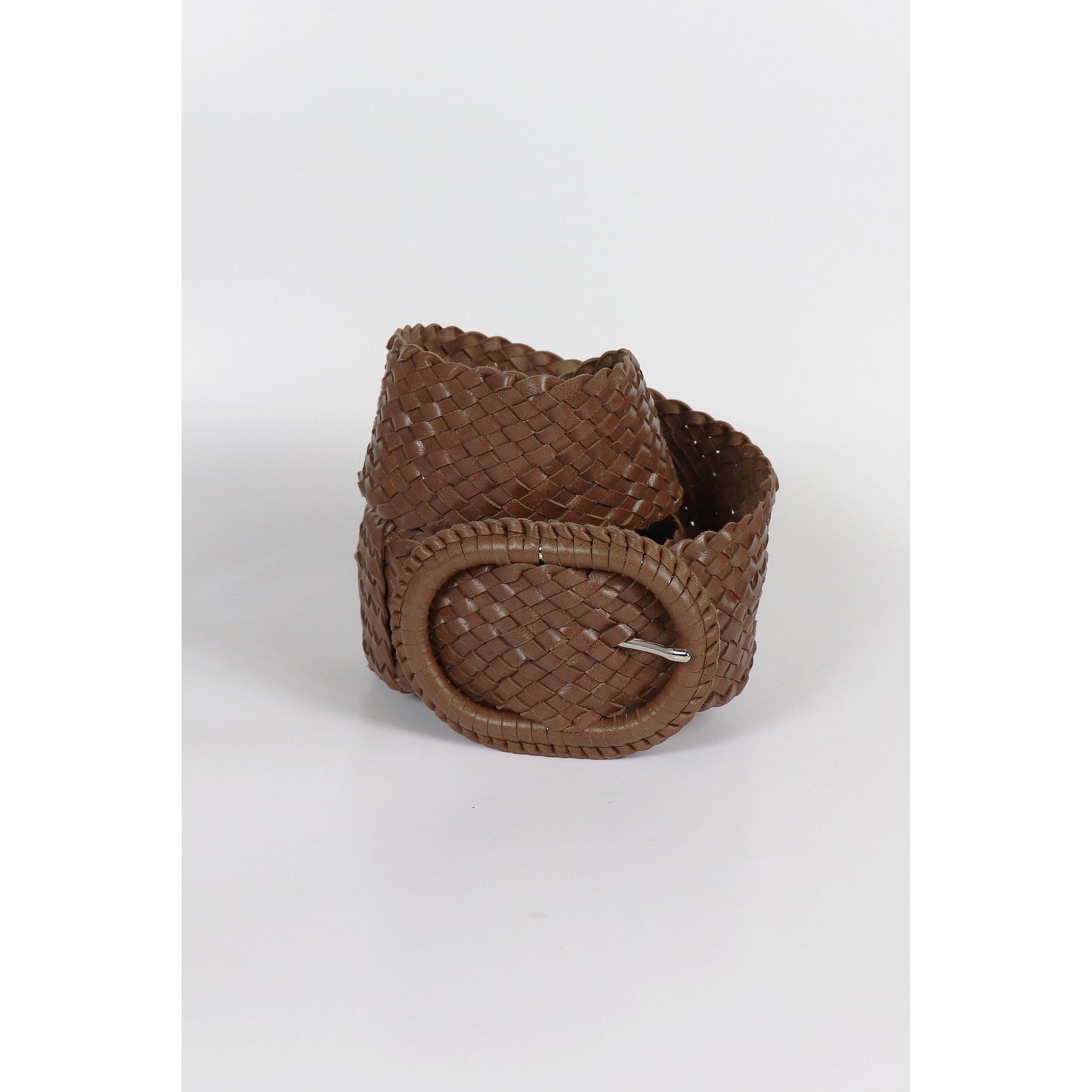 Woven brown leather belt coiled.
