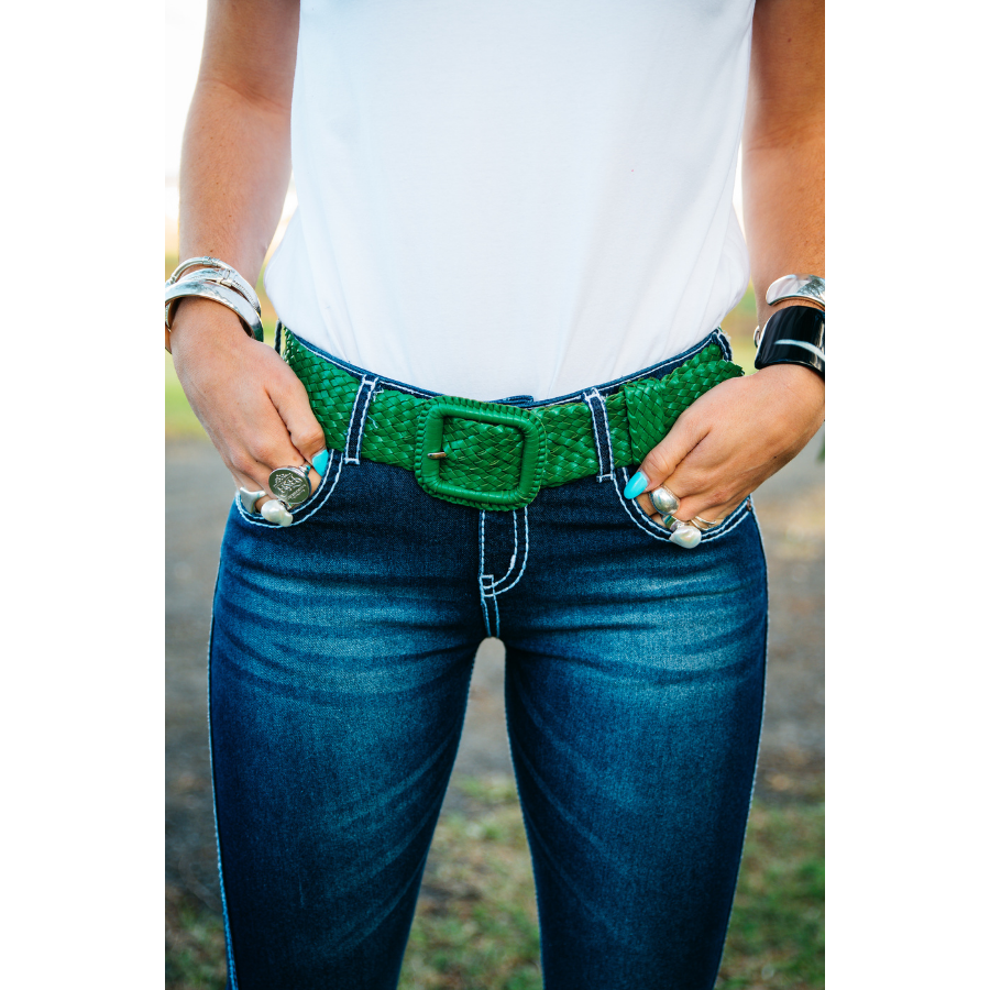 Person holding belt on jeans.