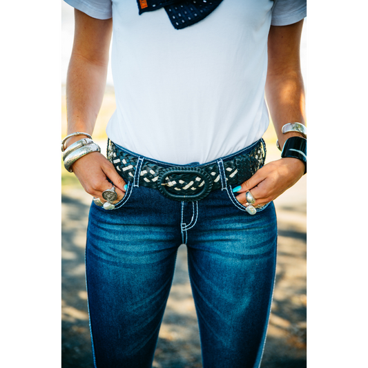 Woman wearing jeans and belt.