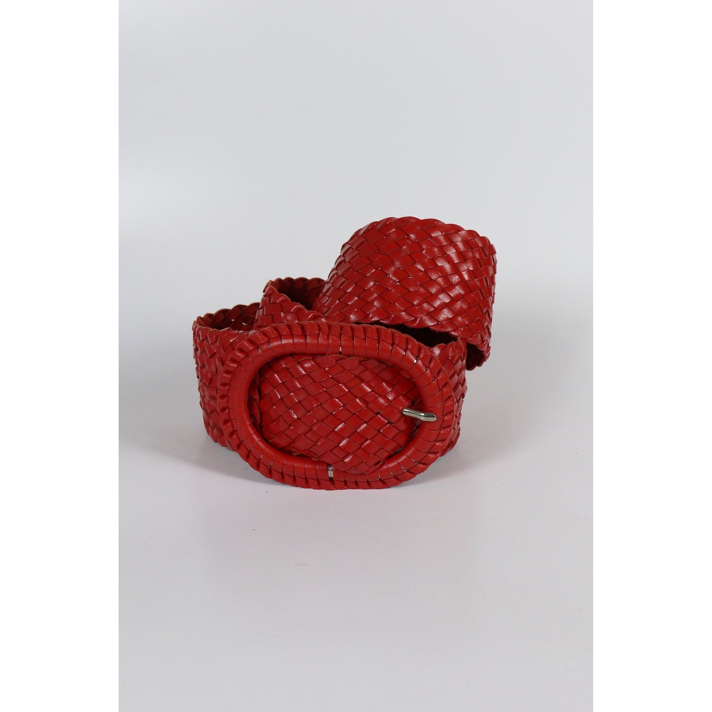 Red woven leather belt coiled.