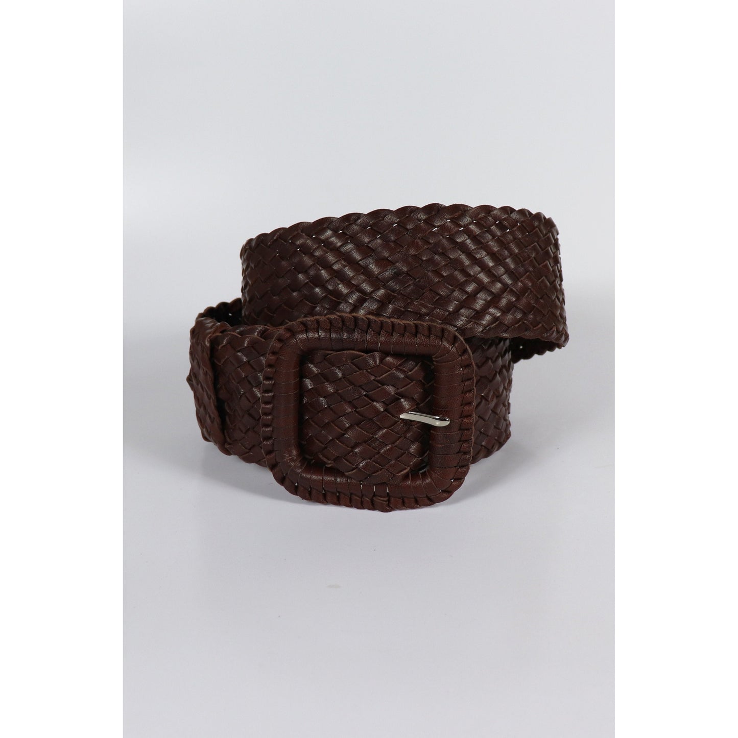 Brown woven leather belt coiled.