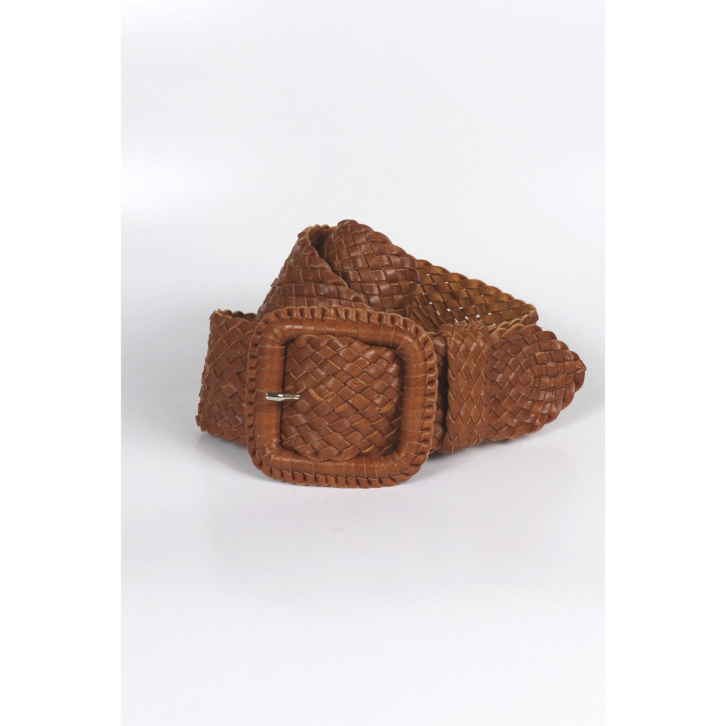 Woven brown leather belt coiled.