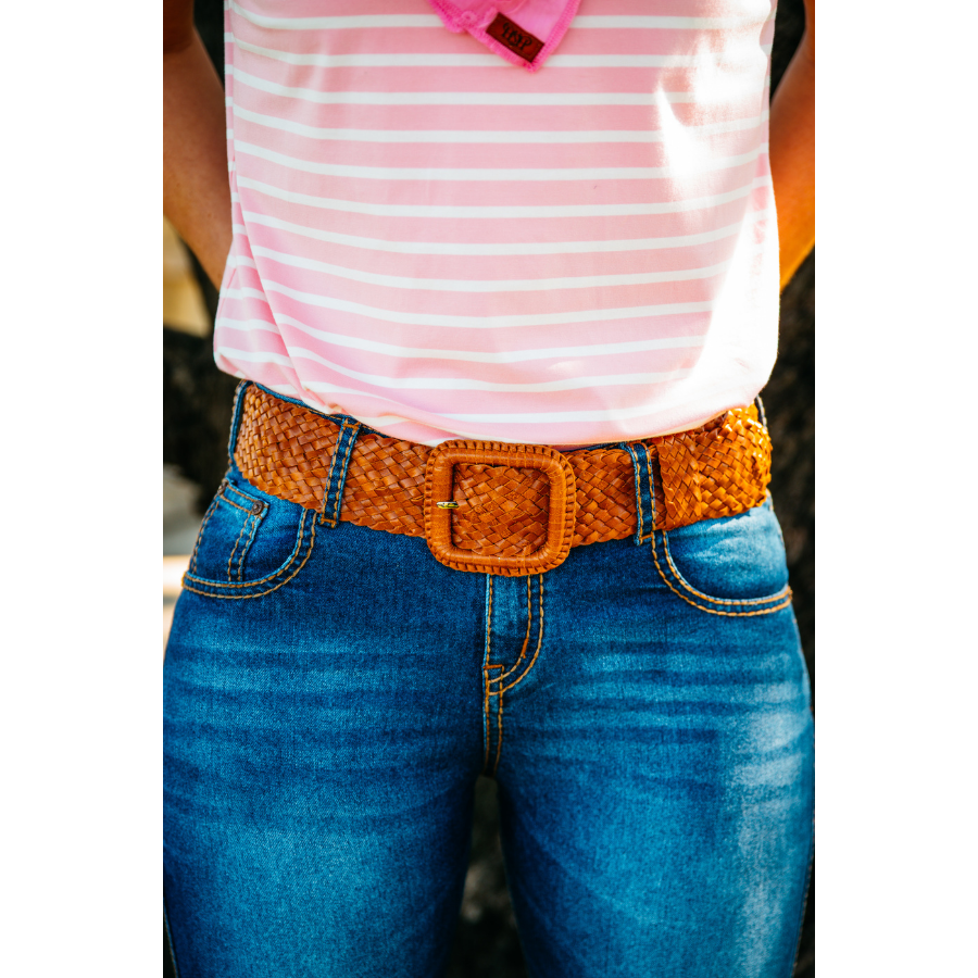 Woman wearing jeans with belt.