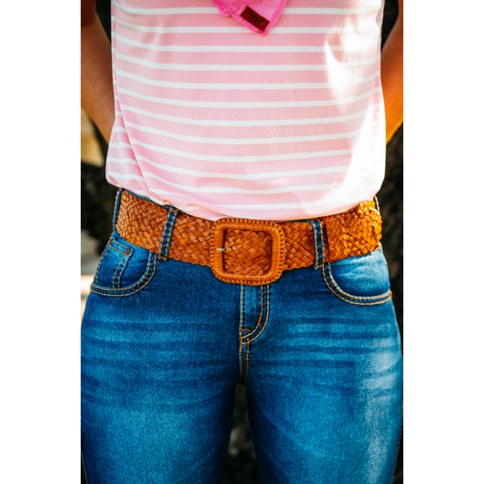 Woman wearing jeans with belt.