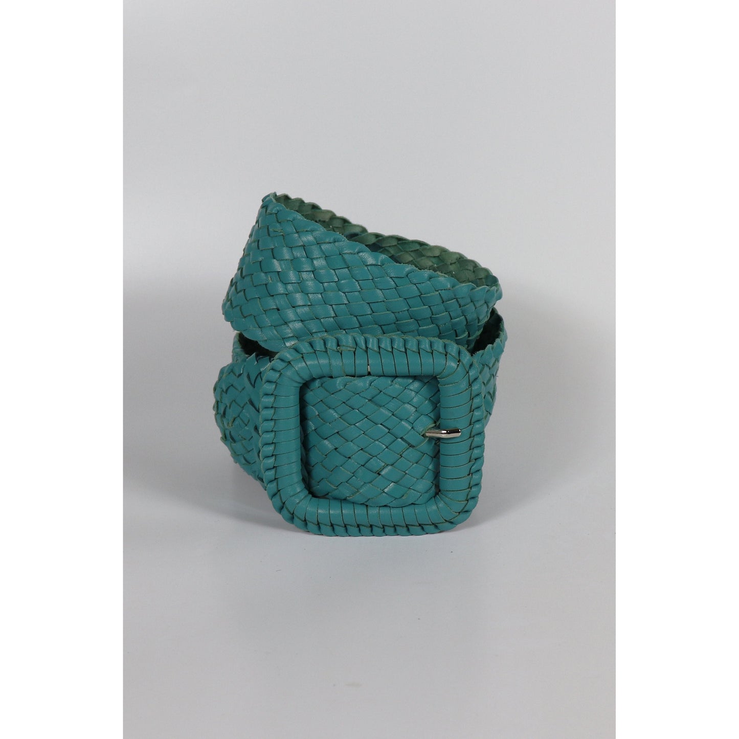 Turquoise woven leather wrist cuff.