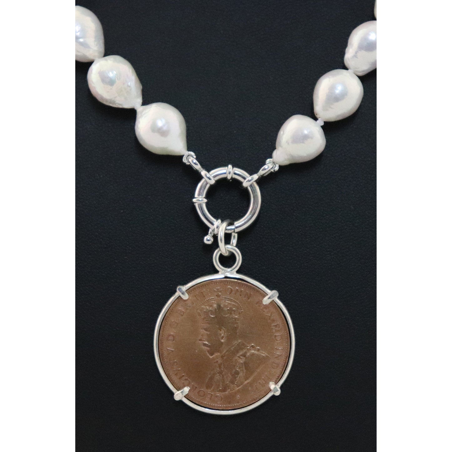 Pearl necklace with coin pendant.