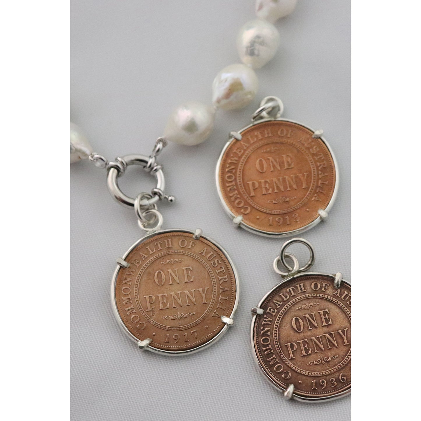 Pearl necklace with penny pendants.