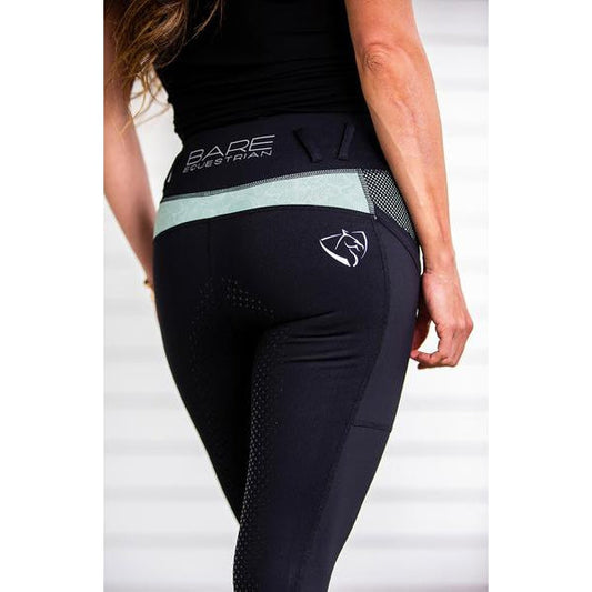 Person wearing black horse riding tights with a logo on them.