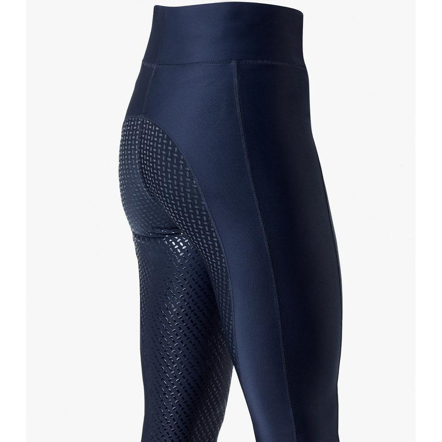 Navy blue horse riding tights with grip pattern on thigh.
