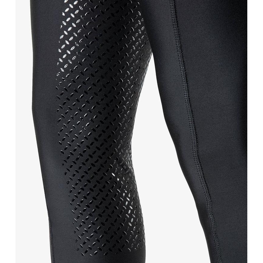 Close-up of black horse riding tights with grip pattern detail.