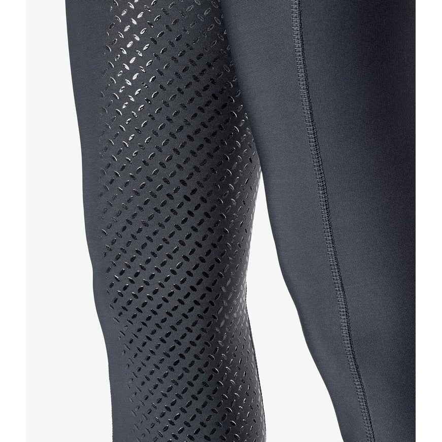 Close-up of black horse riding tights with patterned grip detailing.