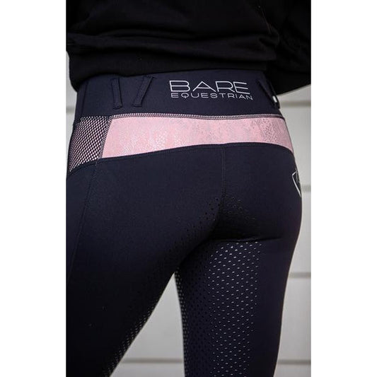 Close-up of black and pink BARE Equestrian horse riding tights.