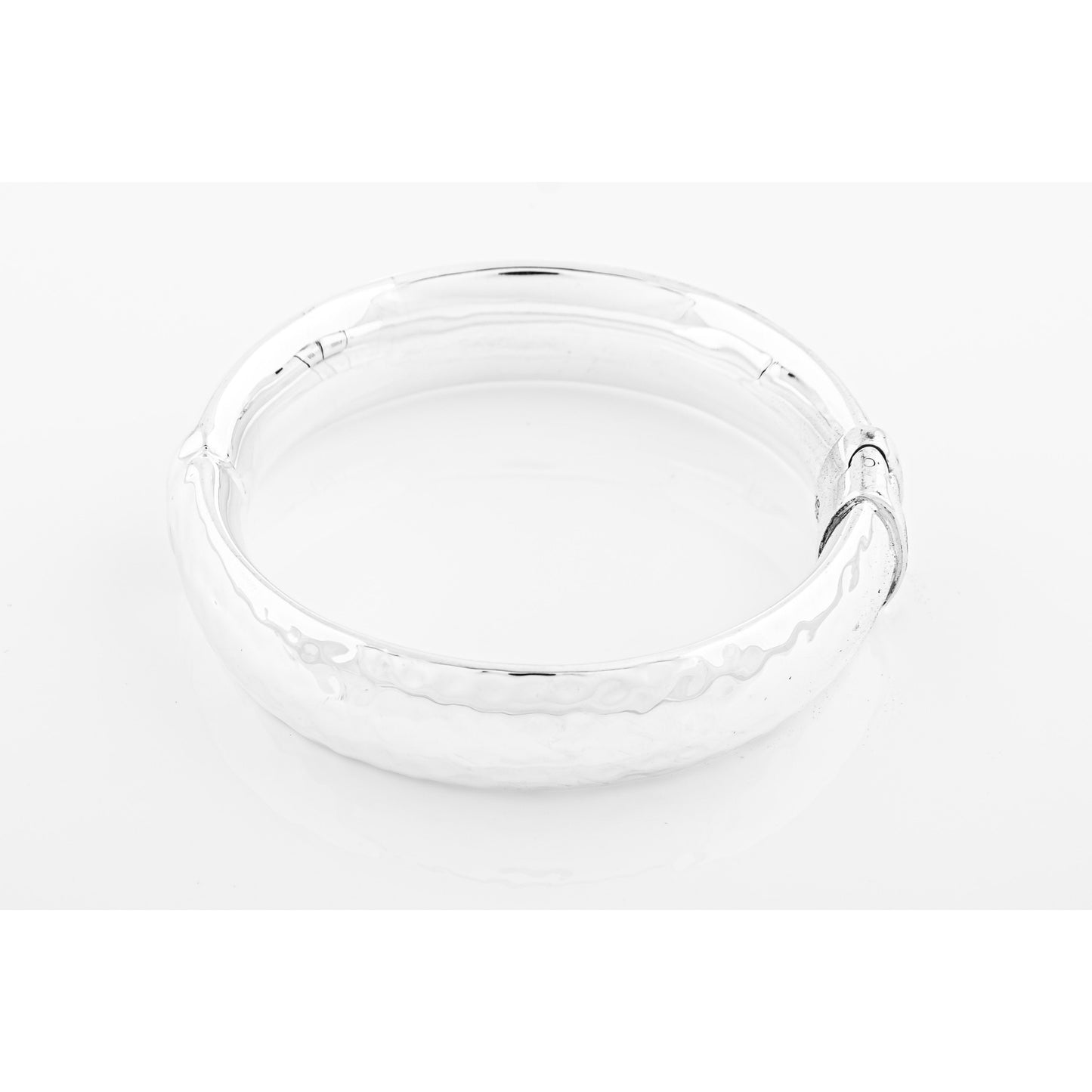 Clear glass ashtray on white.