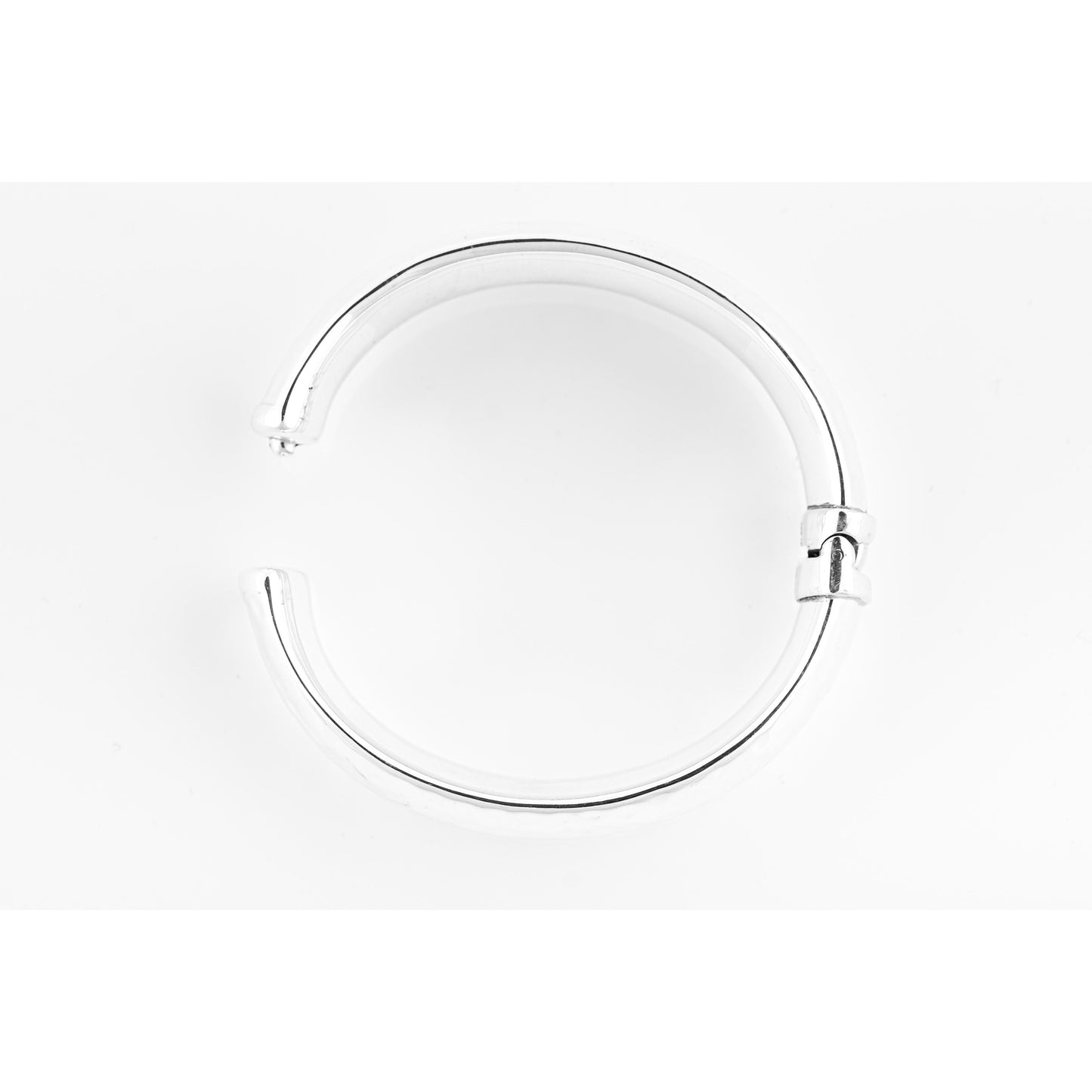 Silver circular object on white.