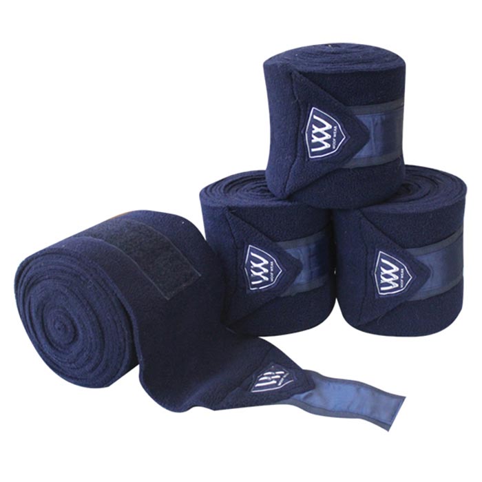 Woof Wear brand navy blue horse leg wraps piled together.
