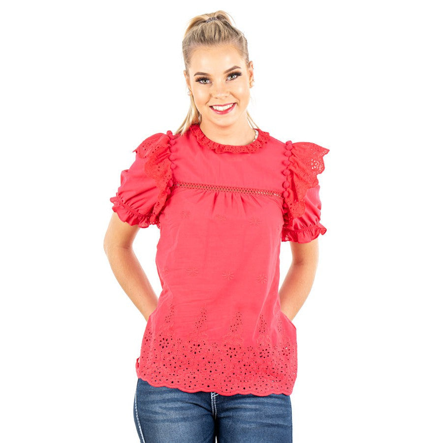 Woman in red blouse smiling.