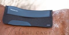 Thinline saddle pad on horseback with Terri Cage logo.