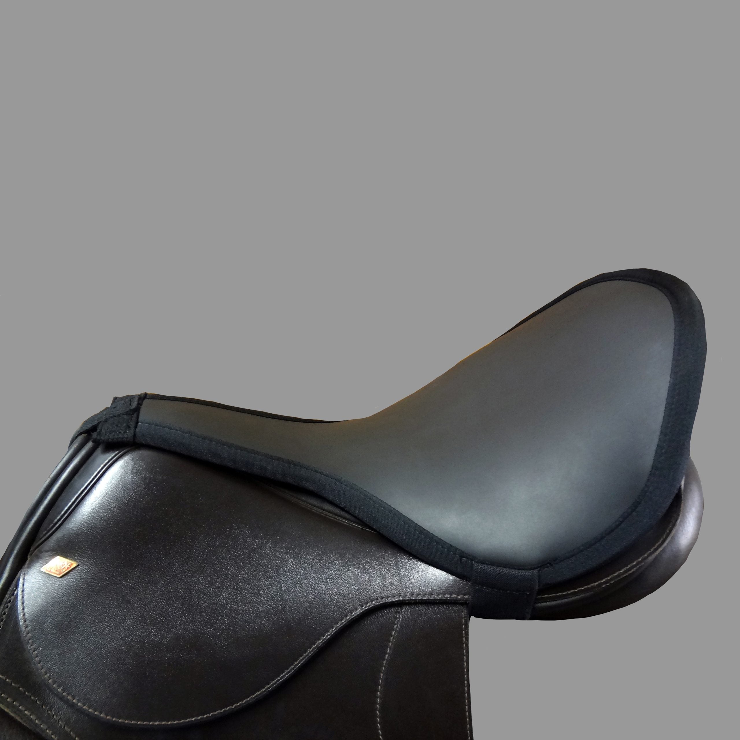 Thinline brand black saddle pad on a black saddle.